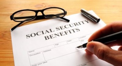 person filling out social security benefits form