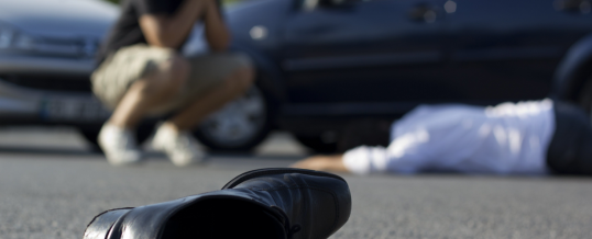 shoe with an injured man laying in the background