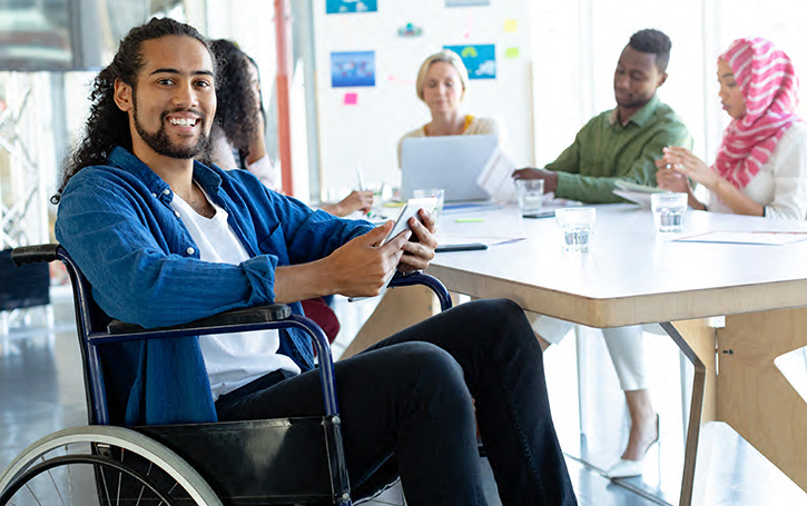 man in wheelchair sitting with a group of people