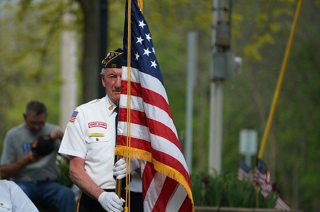 A senior veteran holding a American flag