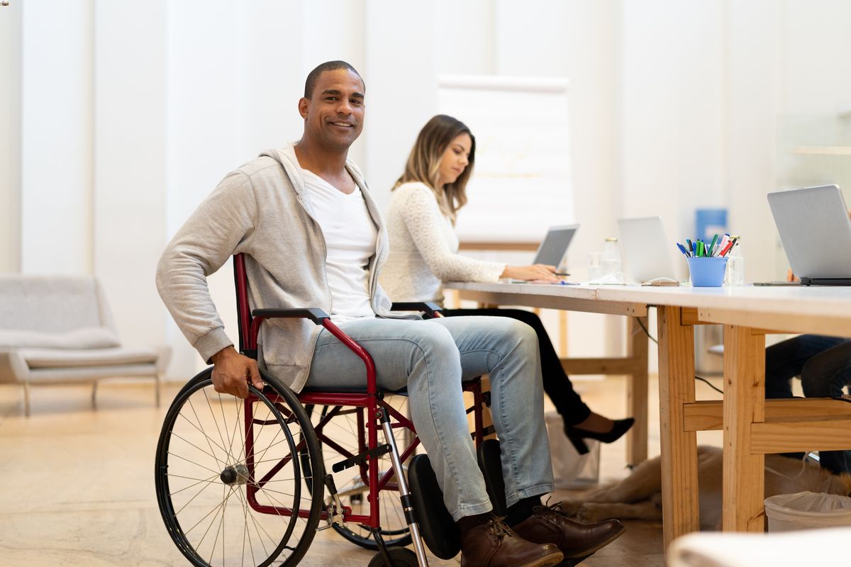 Disabled man in wheelchair at workplace