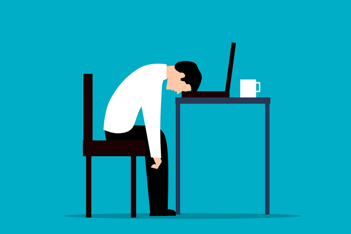 Cartoon of a worker fall asleep on work desk