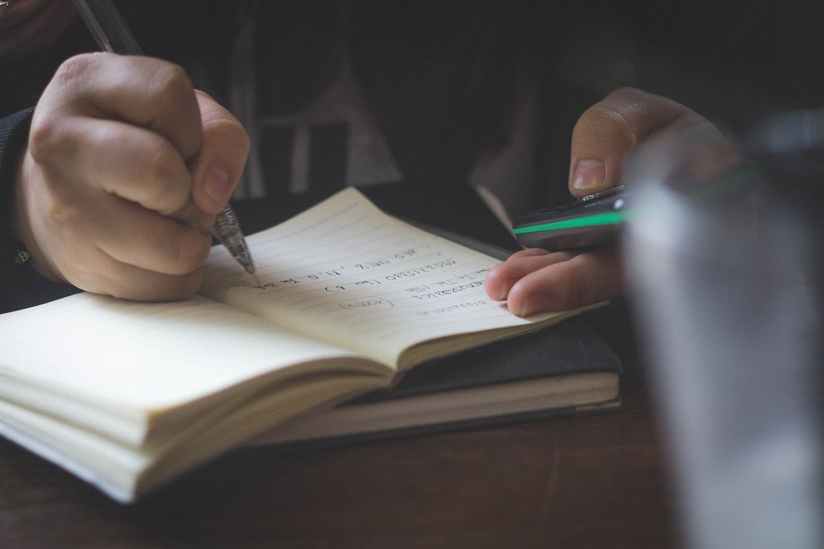 Closeup of a man taking notes